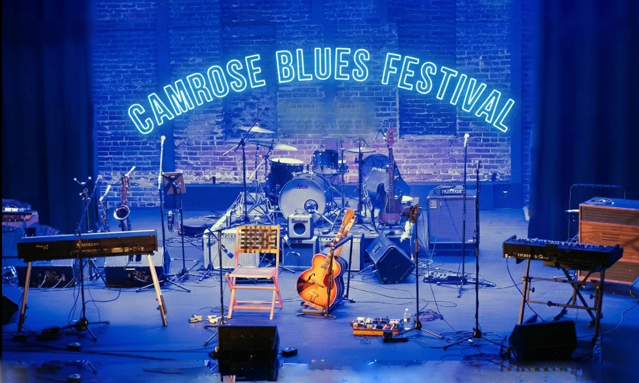 Image of a stage with the words Camrose Blues Festival in an arc over top
