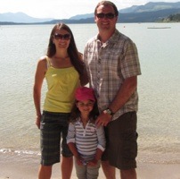 Carla, Brian and Tailia Rogoza standing in front of Invermere Lake. 