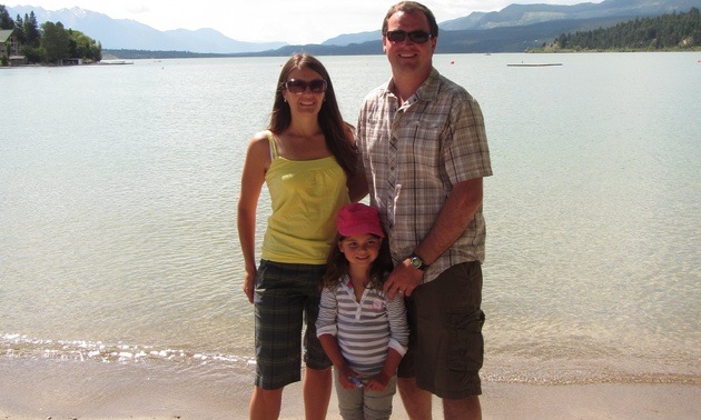 Carla, Brian and Tailia Rogoza standing in front of Invermere Lake. 