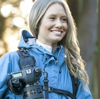 A women using a StrapShot with her camera attached.