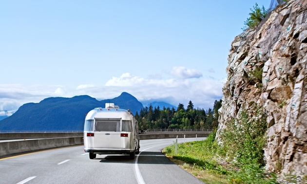 boler RV taking a turn around a mountain road corner