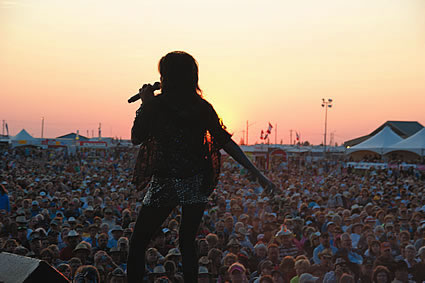 Stage with musicians playing and the crowd in the background