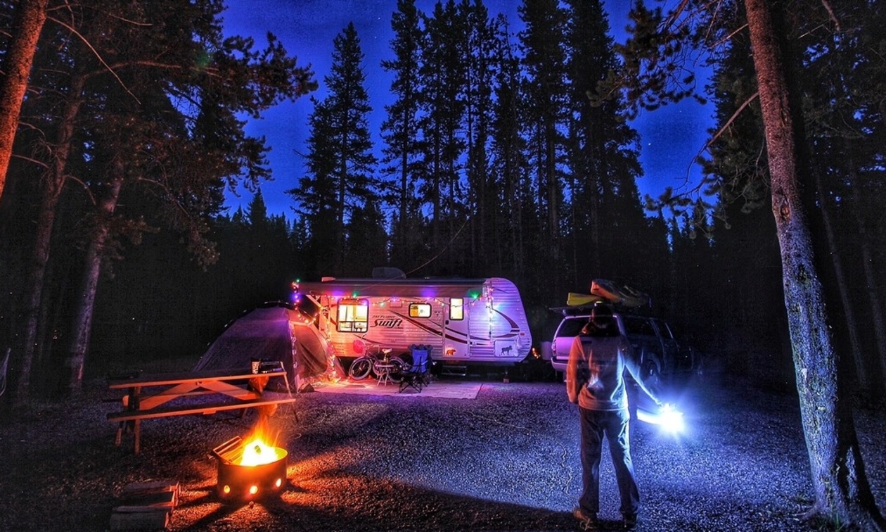 A campsite set up at night with lights 