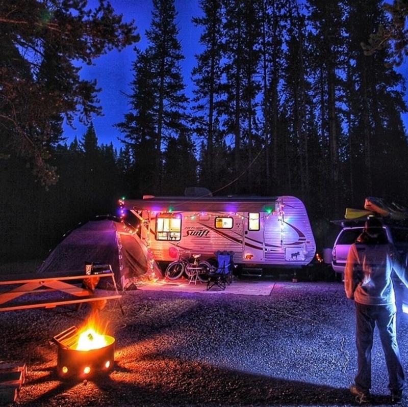 A campsite set up at night with lights 