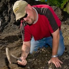 Man on dig site with pick