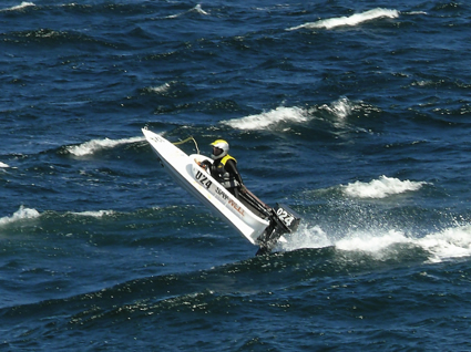 A person during the race attempting to overtake the ocean waves.