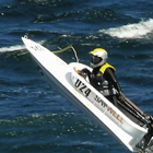 A person during the race attempting to overtake the ocean waves.