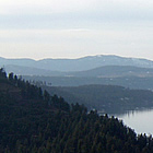 aerial photo with mountains surrounding a lake