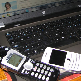 computer and a pair of cell phones