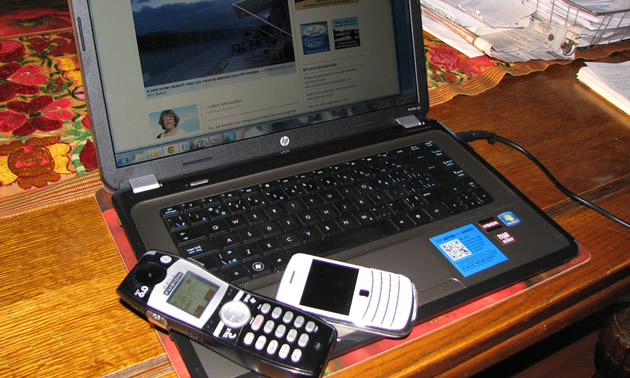 computer and a pair of cell phones