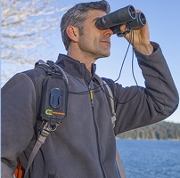 A man looking through binoculars.