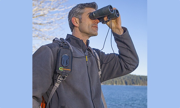A man looking through binoculars.