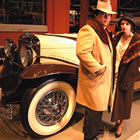 classic car with two people standing in '20s attire