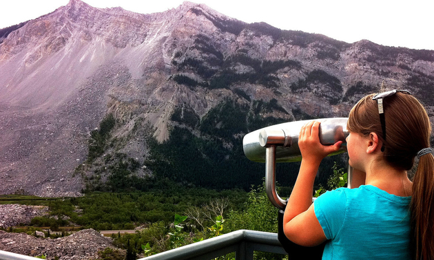 Logan Shellborn takes a better look at the 30 million cubic meters of limestone that crashed from the summit of Turtle Mountain on April 29, 1903.
