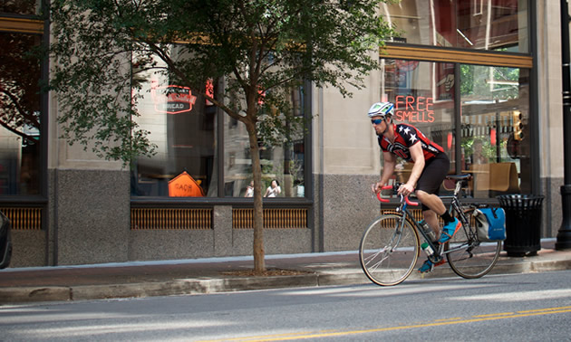 A cyclist rides down the streets of downtown Tulsa.