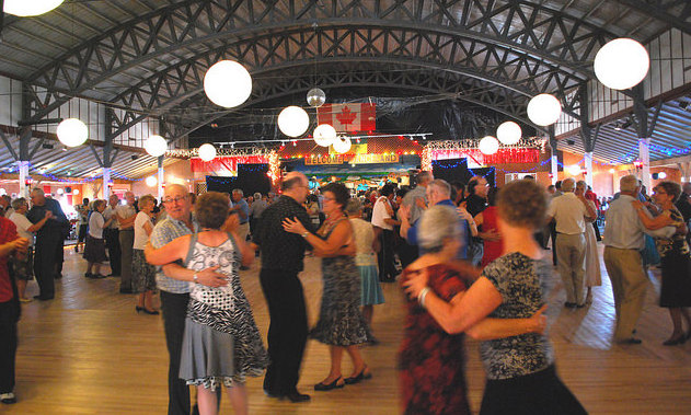 Dozens of couples dancing on the hardwood floor of Danceland.  