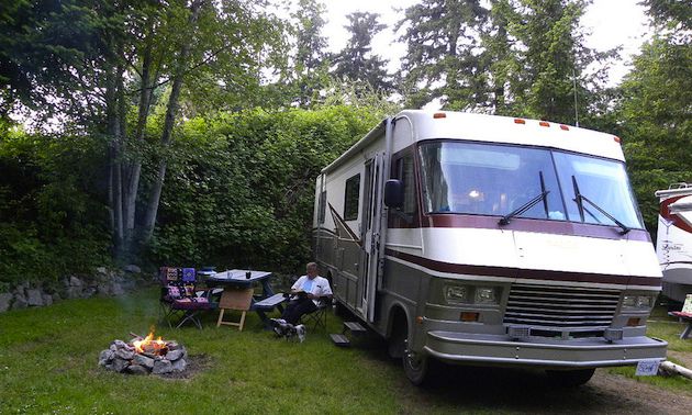 Man in a lawnchair beside a motorhome