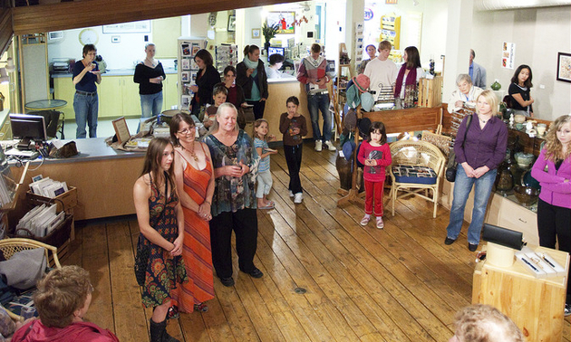 people dressed up standing in an art gallery