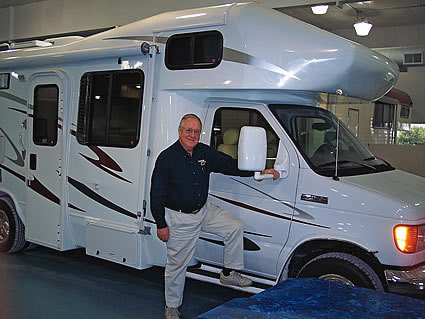 Person standing beside an RV