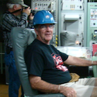 Man wearing hardhat sitting at a desk