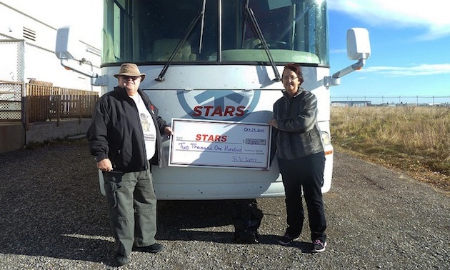 Duane and Linda Pilson with a cheque for STARS air ambulance.