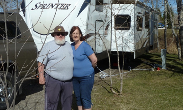 Duane and Lynda Pilson standing outside of their RV.