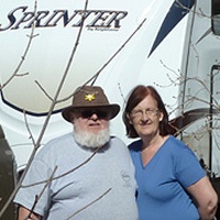 Duane and Lynda Pilson standing outside of their RV.