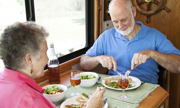 Photo of a couple eating in their RV