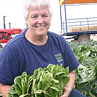 woman holding a head of lettuce