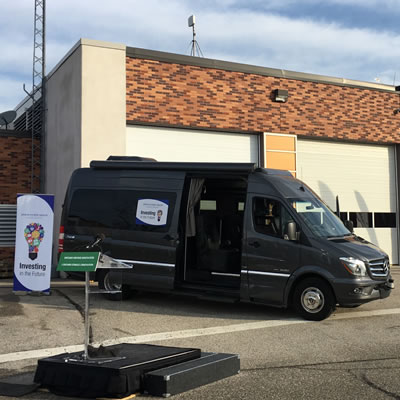 Picture of black Erwin Hymer van in parking lot. 