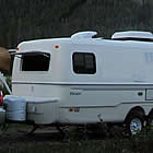 car pulling a trailer in the mountains