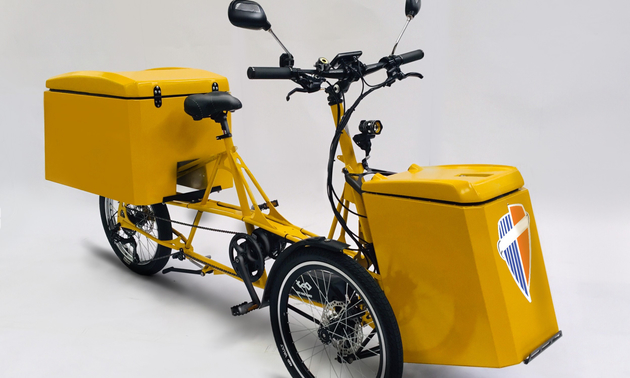 yellow e-trike with cargo baskets in front and back