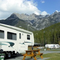 An RV parked at Fairmont RV park, with a view of the mountains in the background. 