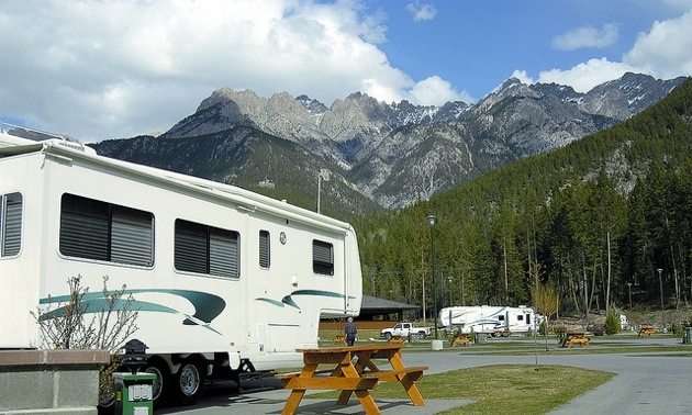 An RV parked at Fairmont RV park, with a view of the mountains in the background.