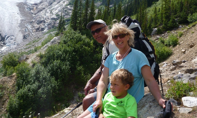 Man, woman and child on a mountain.