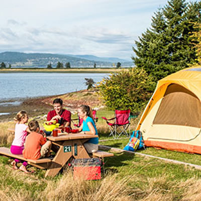 Family camping by lakeshore. 