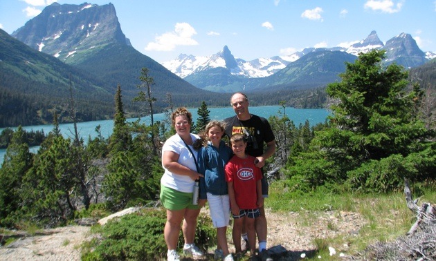 The Srubowich family with their backs to a view at the Going-to-the sun Road in Glacier Naional Park, Montana.