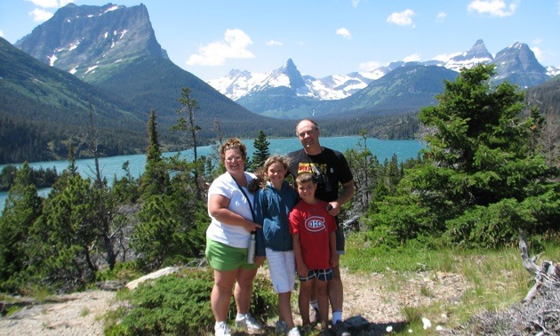 The Srubowich family with their backs to a view at the Going-to-the sun Road in Glacier Naional Park, Montana. 