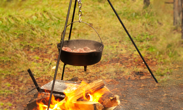 open fire with food cooking over it