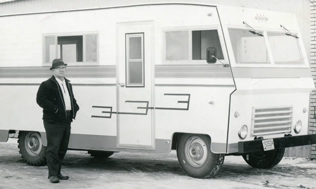 One of the first Triple E motorhomes ever built, with man standing in front of it. 