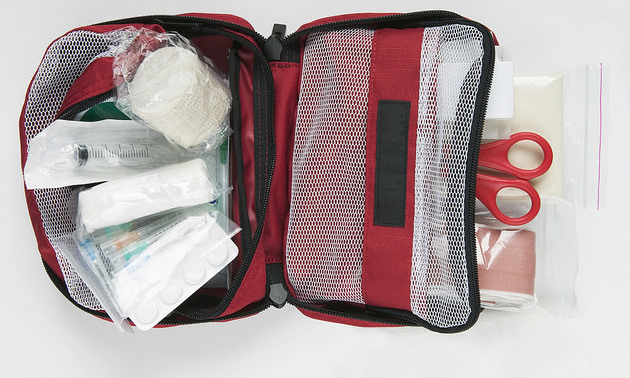 A first aid kit that is open to show its contents. 