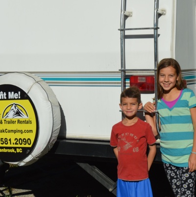 Daphne and Oliver Gonzalez standing next to their rented 28' Vanguard RV.