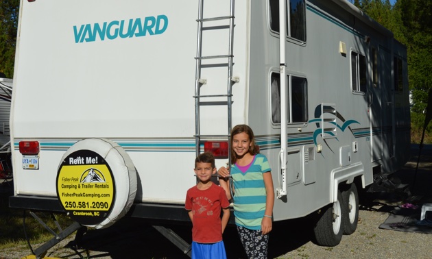 Daphne and Oliver Gonzalez standing next to their rented 28' Vanguard RV.