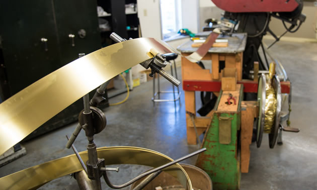 This press has been thump-thump-thumping out brass spoons since Len Thompson purchased it used in 1946.