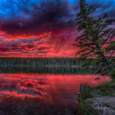 One of Ross Johnson's photographs: Fish Lake at sunset with a dramatic red sky