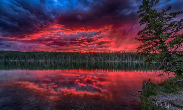 One of Ross Johnson's photographs: Fish Lake at sunset with a dramatic red sky