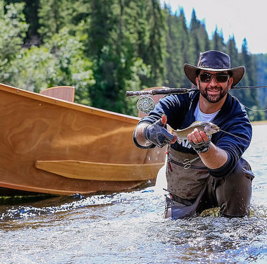 Adriano Lafauci with his catch. Antique wooden drift boats provide the perfect transportation as guests drift down the river. In day trips, guests can expect about six stops to fish the pools along the way.