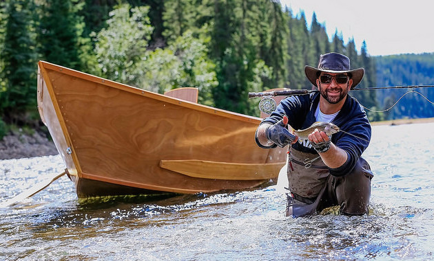 Adriano Lafauci with his catch. Antique wooden drift boats provide the perfect transportation as guests drift down the river. In day trips, guests can expect about six stops to fish the pools along the way.