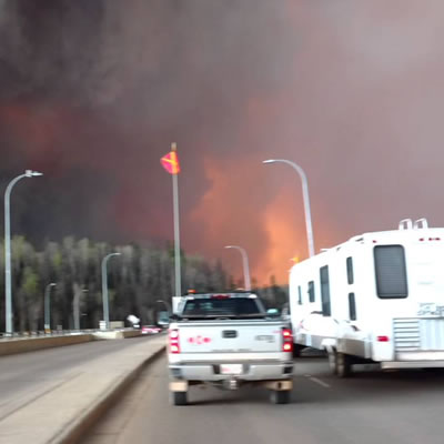 A YouTube photo of a Fort McMurray resident escaping the burning city with trailer in tow. 