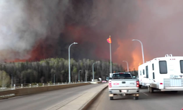 A YouTube photo of a Fort McMurray resident escaping the burning city with trailer in tow. 